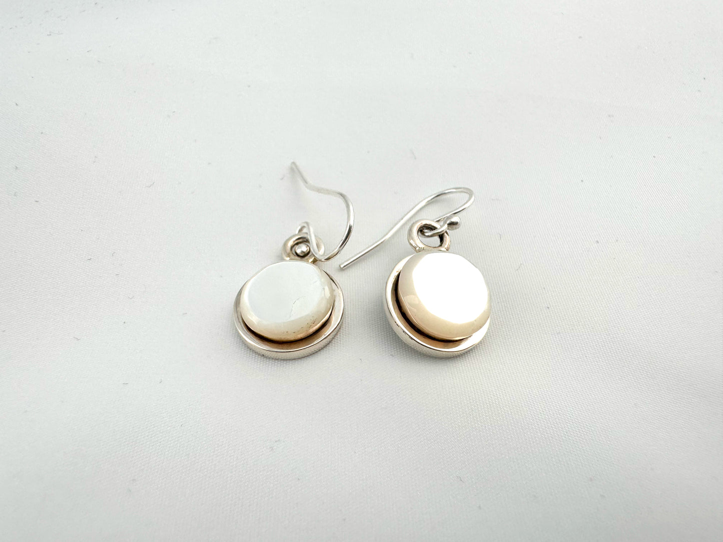 Silver and mother of pearl earrings by Causanda Dukepoo (Taos)