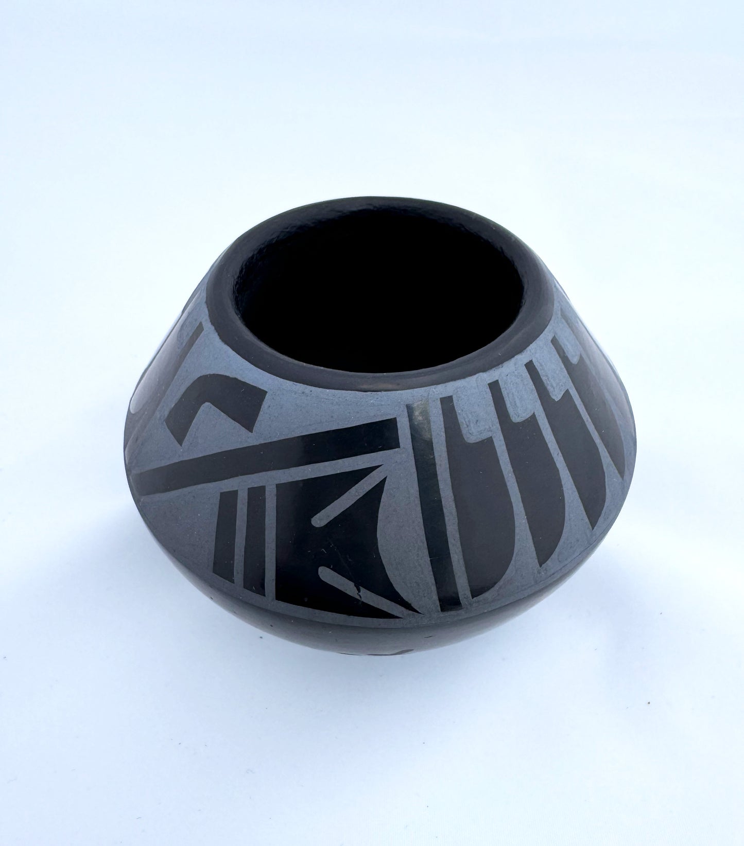 Miniature blue on black bowl by Erik "Than Tsideh" Fender (San Illdefonso)