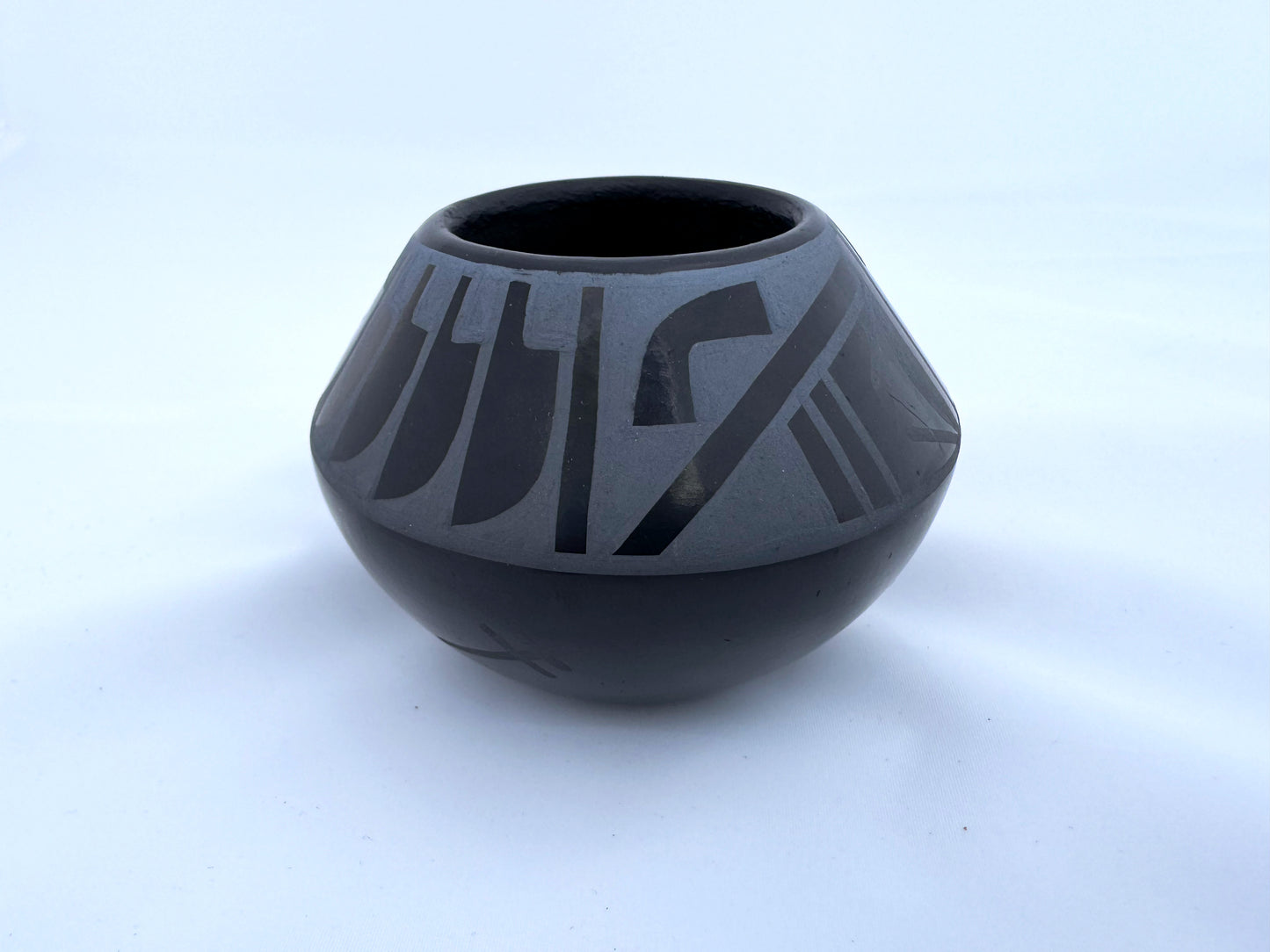 Miniature blue on black bowl by Erik "Than Tsideh" Fender (San Illdefonso)